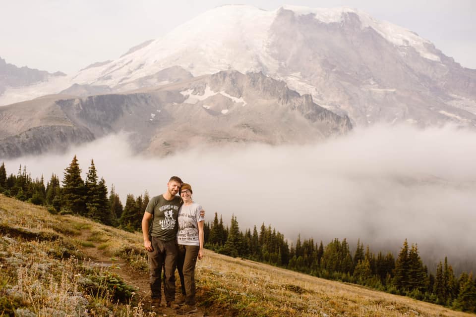 A couple smile for a photo on the Wonderland Trail around Mt Rainier.