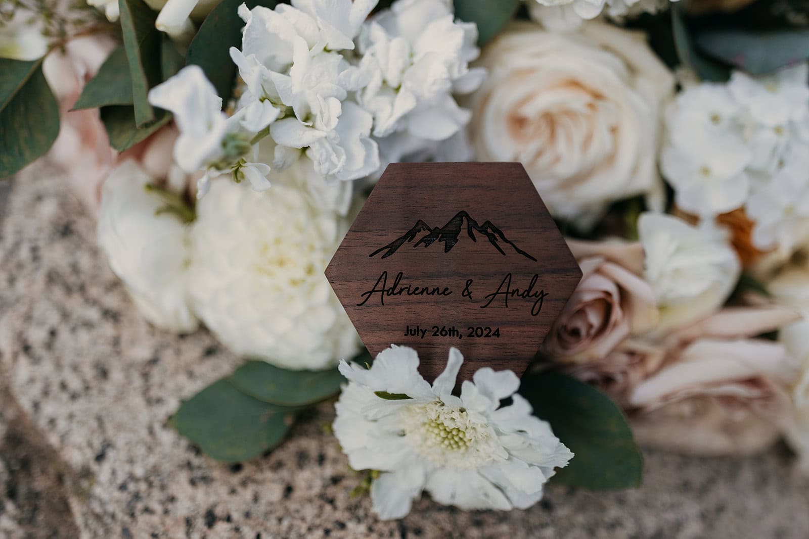A flat lay detail image of a wedding ring box and vow books