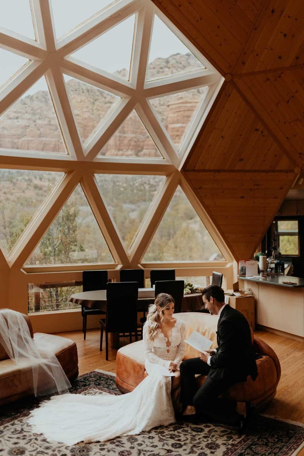 A bride and groom sit together and share their personal vows.