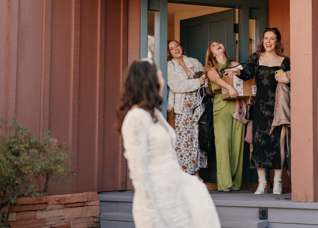 A bride looks back at her friends as she leaves her stay