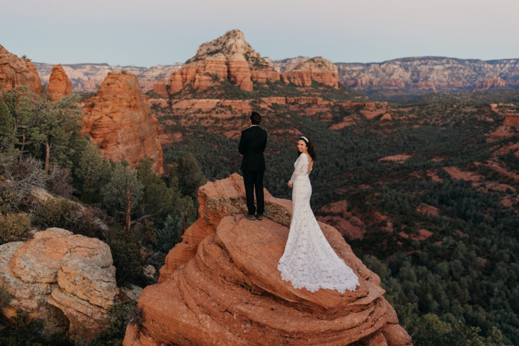 A bride looks back at the camera before going in to share a first look with her groom.
