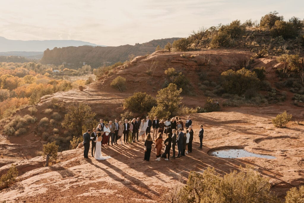 A far away shot of a ceremony in sedona arizona at sunset