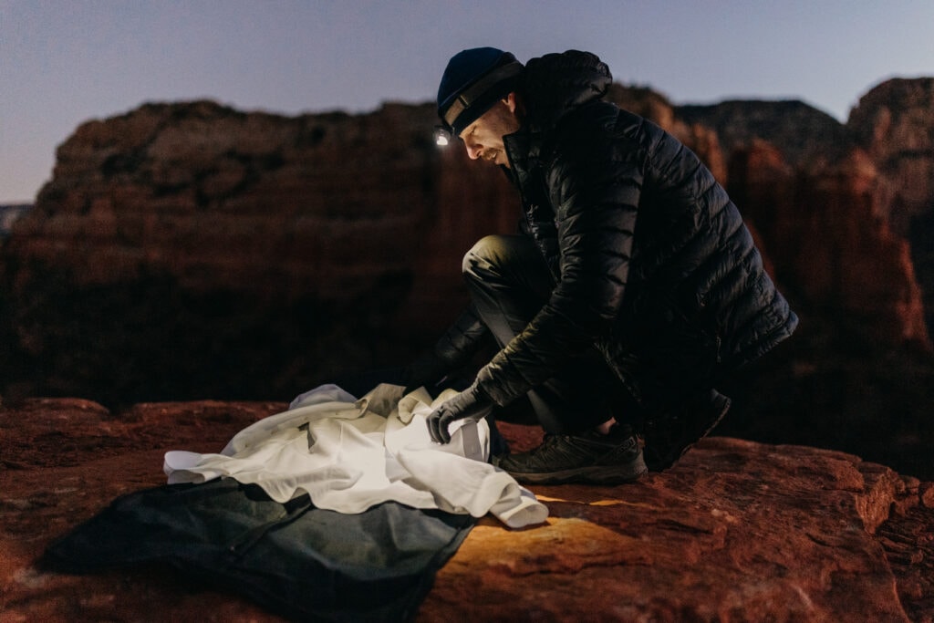 A groom gets ready at sunrise in Sedona for his first look