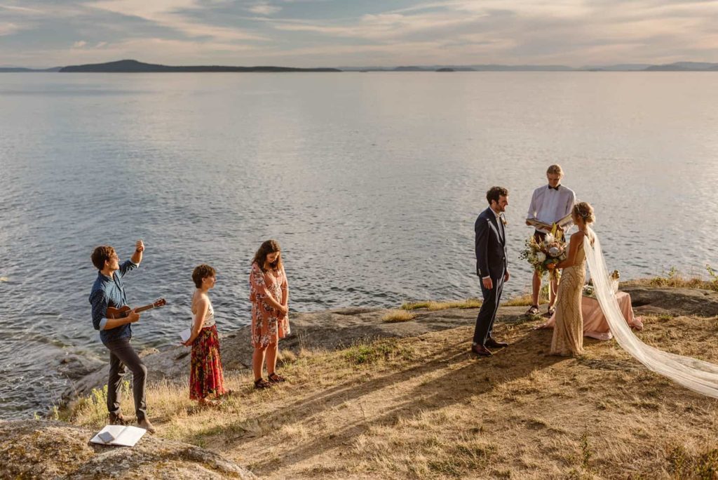 A far away detail photo of a couple during their wedding ceremony on Sucia Island.