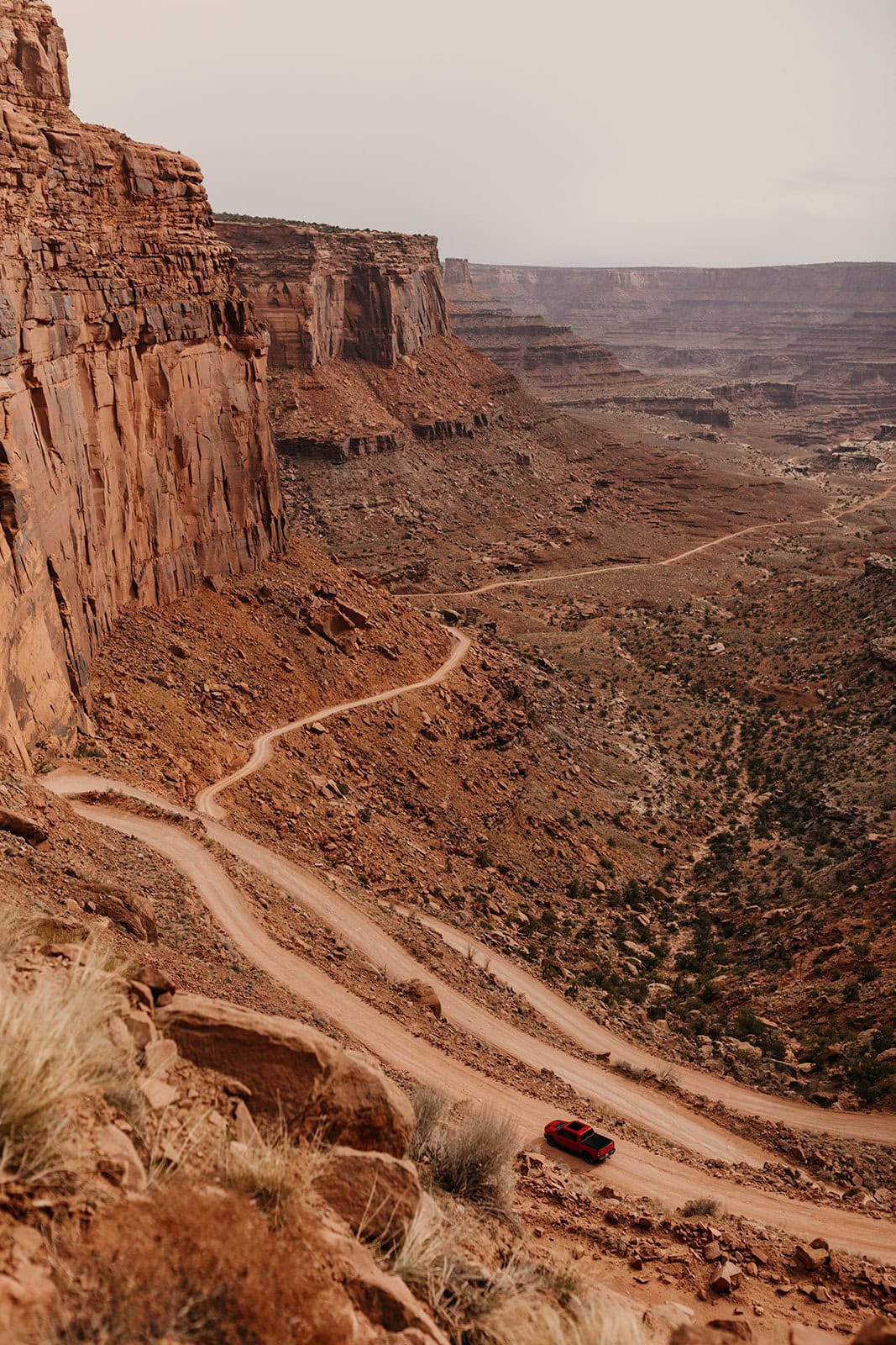Up High views from Shafer Trail and a red truck in the image