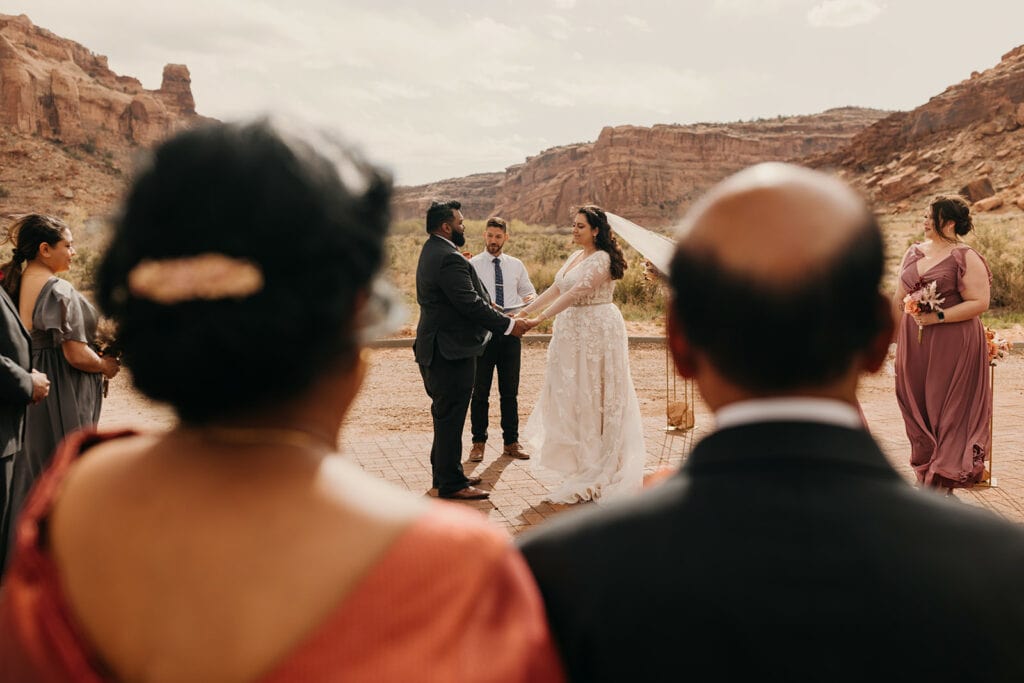 The grooms parents watch the ceremony at red earth venue.