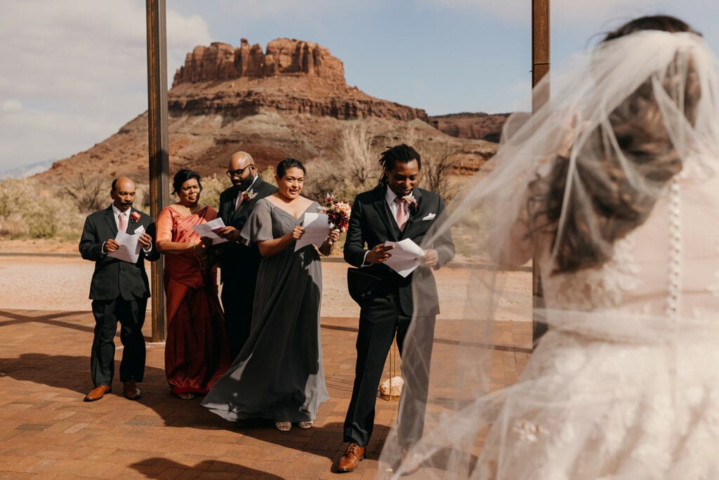 The grooms party read over what they need to read.
