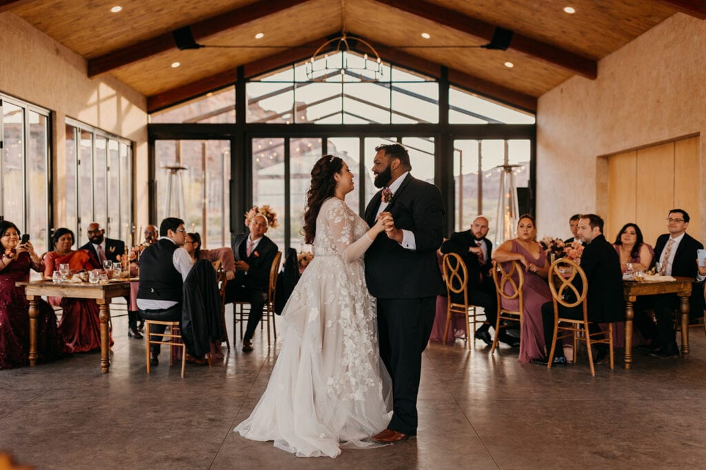 A couple shares their first dance at Red Earth venue.