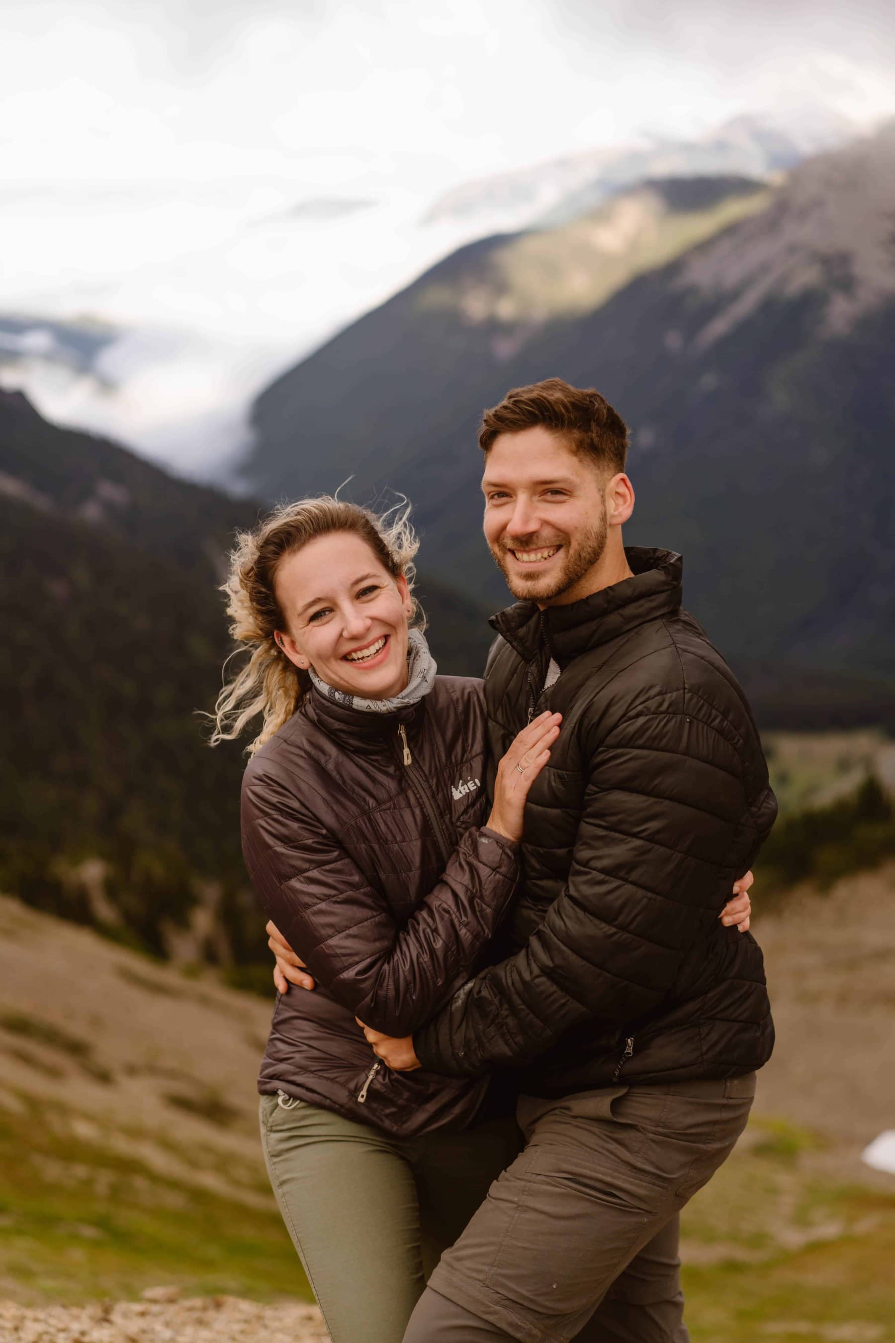 A couple smiles for a portrait together.