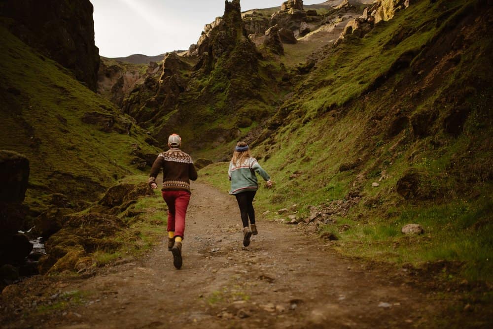A couple runs ahead on the trail.