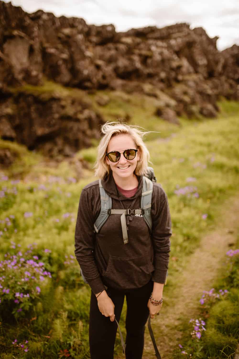 Portrait of a blonde girl smiling at the camera.