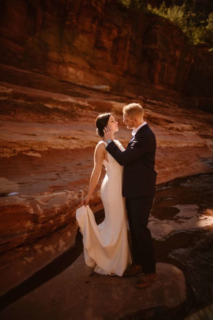 A romantic moment of the groom pushing the brides hair behind her ear.