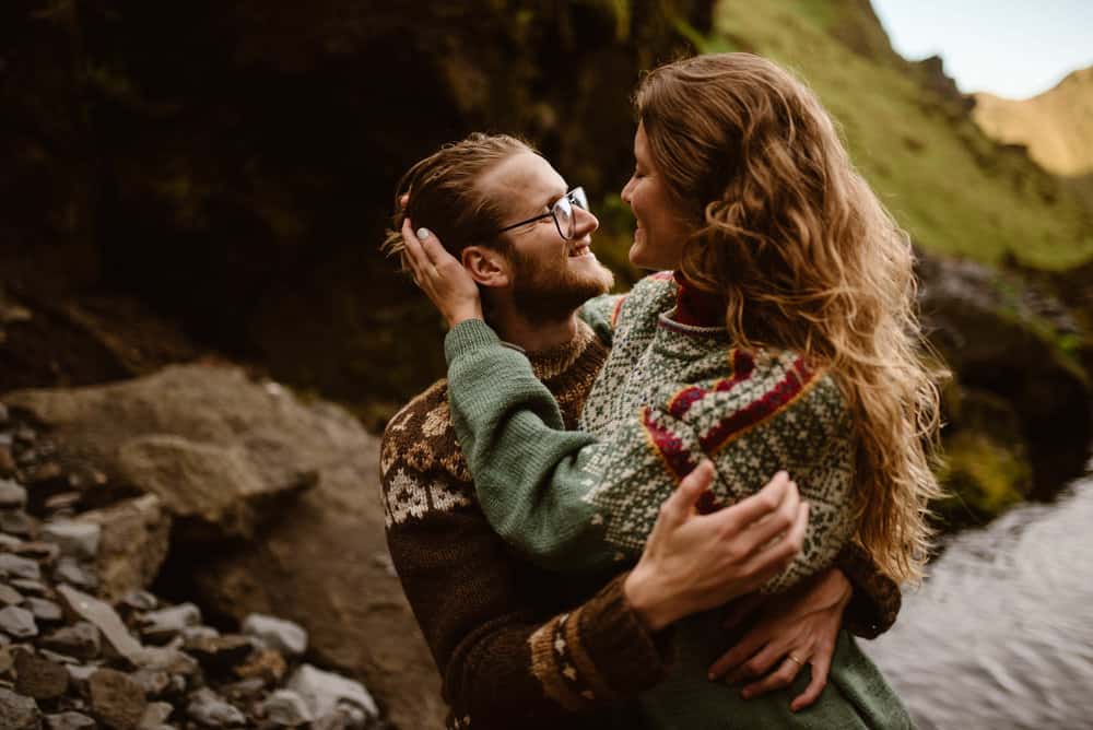 A couple holds each other and looks into each others eyes.