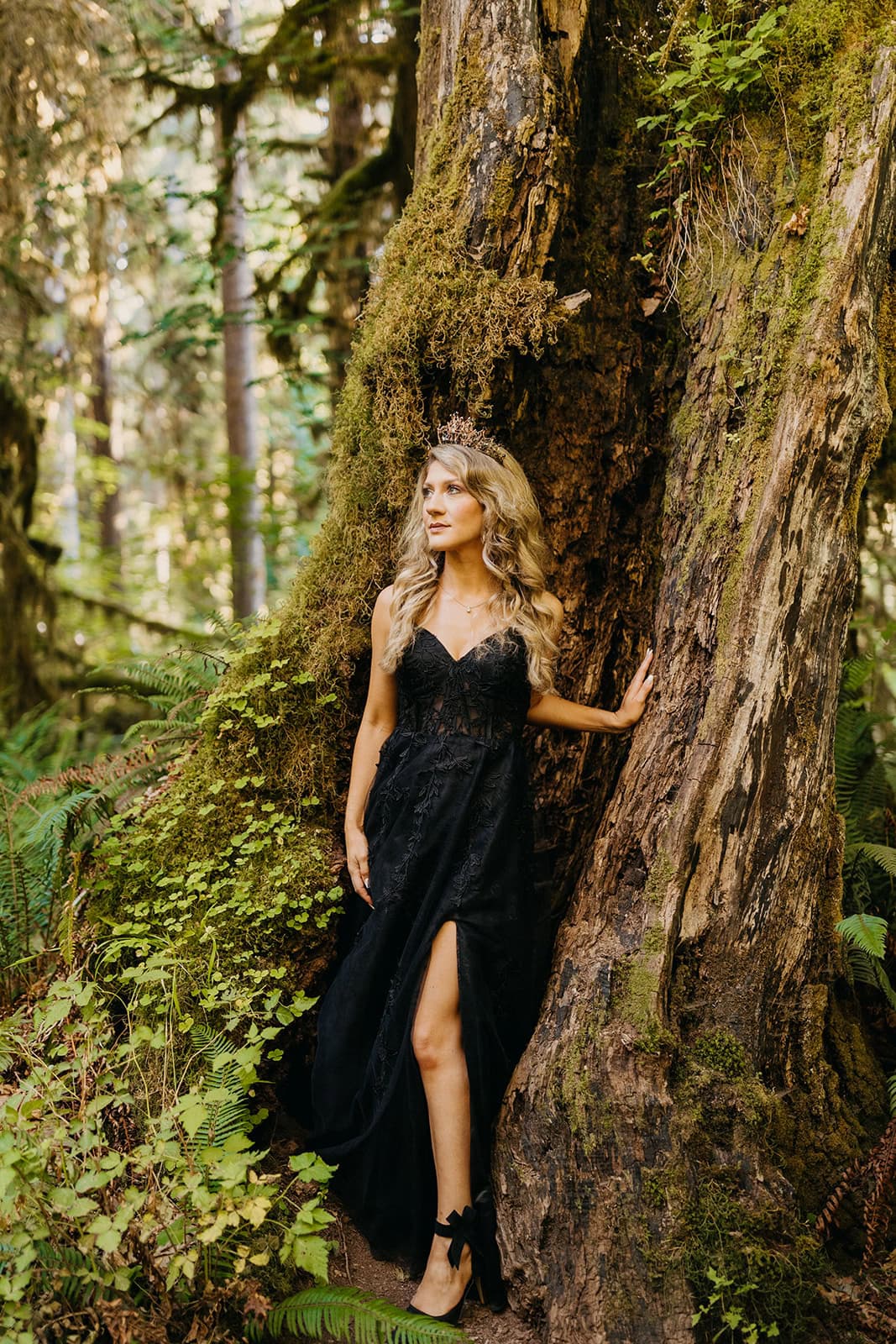 A portrait of a bride in a black wedding dress and crown.