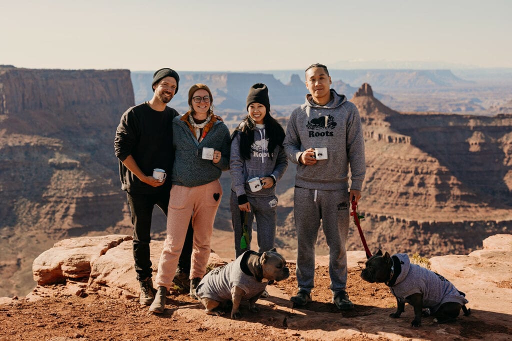 Group photo of the couple, their dogs and their elopement photo video team.