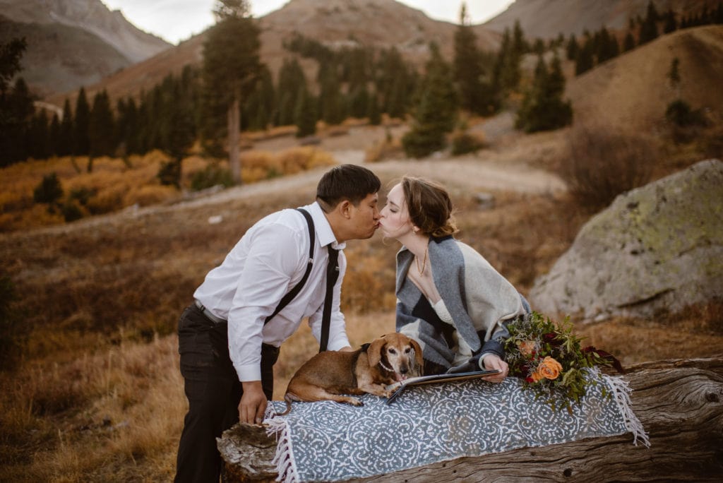 A couple shares a kiss after signing their marriage license.
