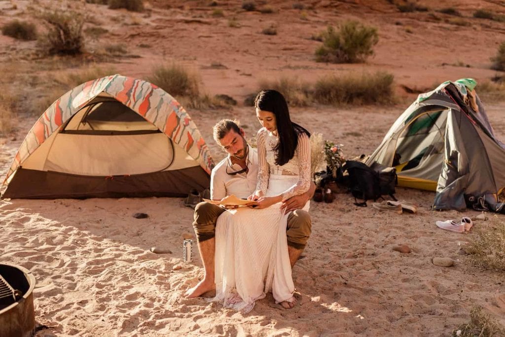 A bride and groom sign their marriage license at camp.