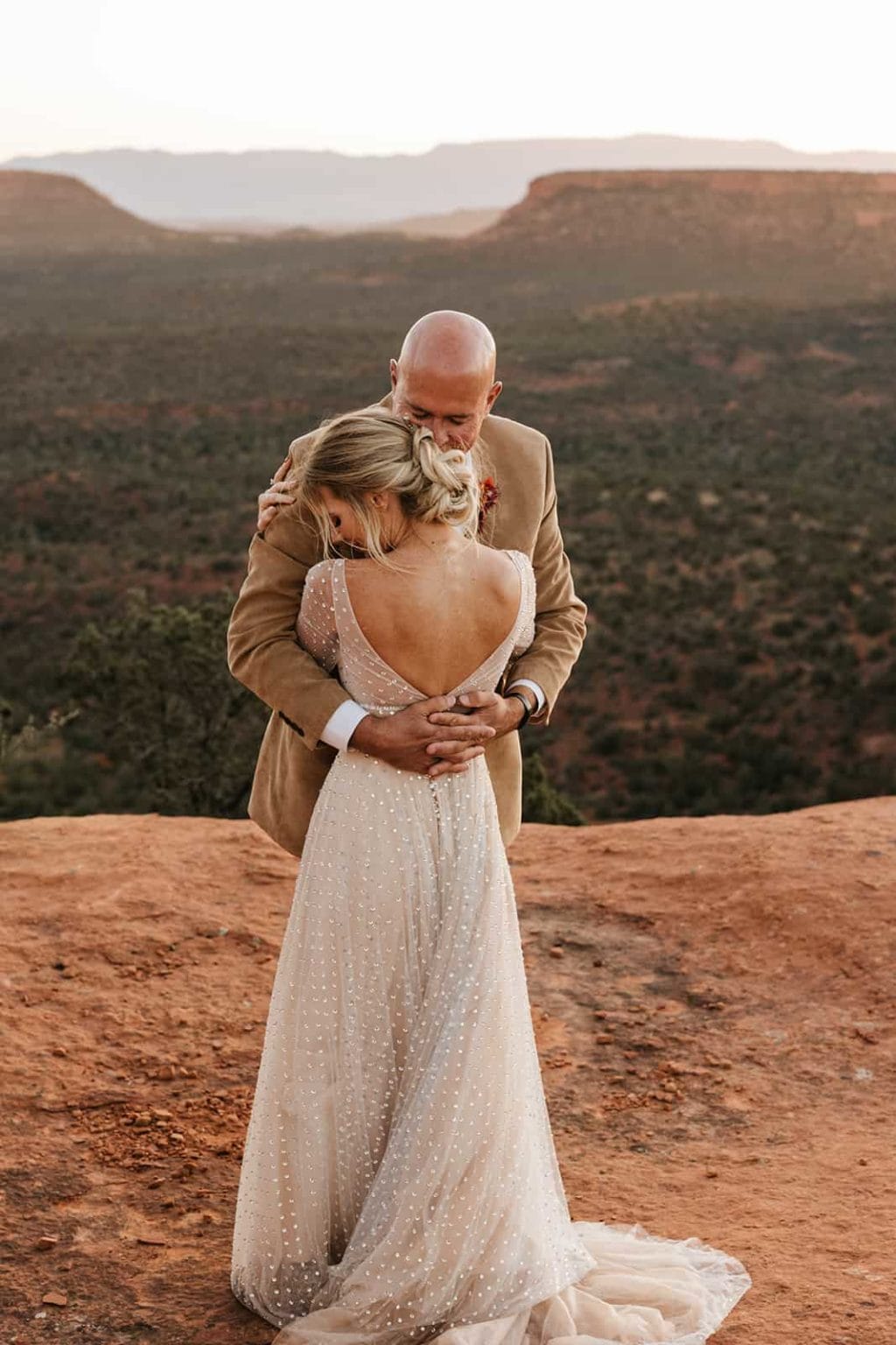 A bride and groom hold each other close in Sedona.
