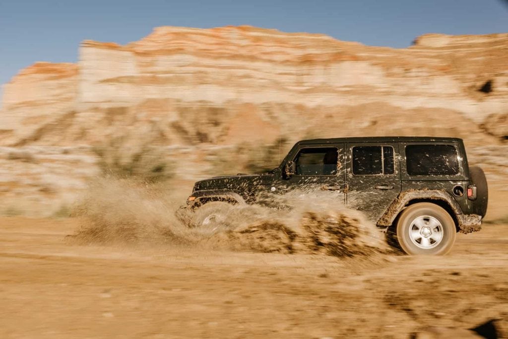 Someone drives through water in their jeep