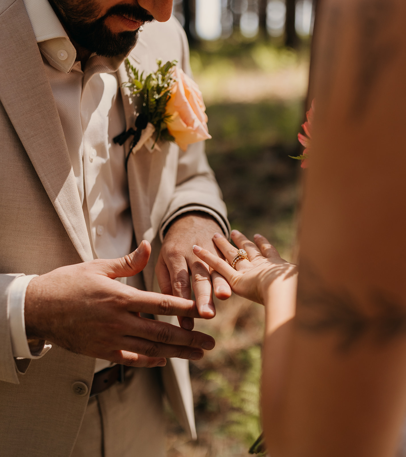 The bride and groom look at their wedding rings.