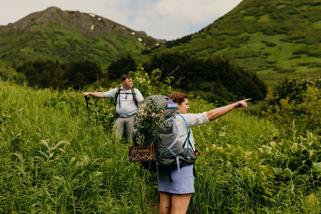 The bride points to a ridge across the way on the trail.