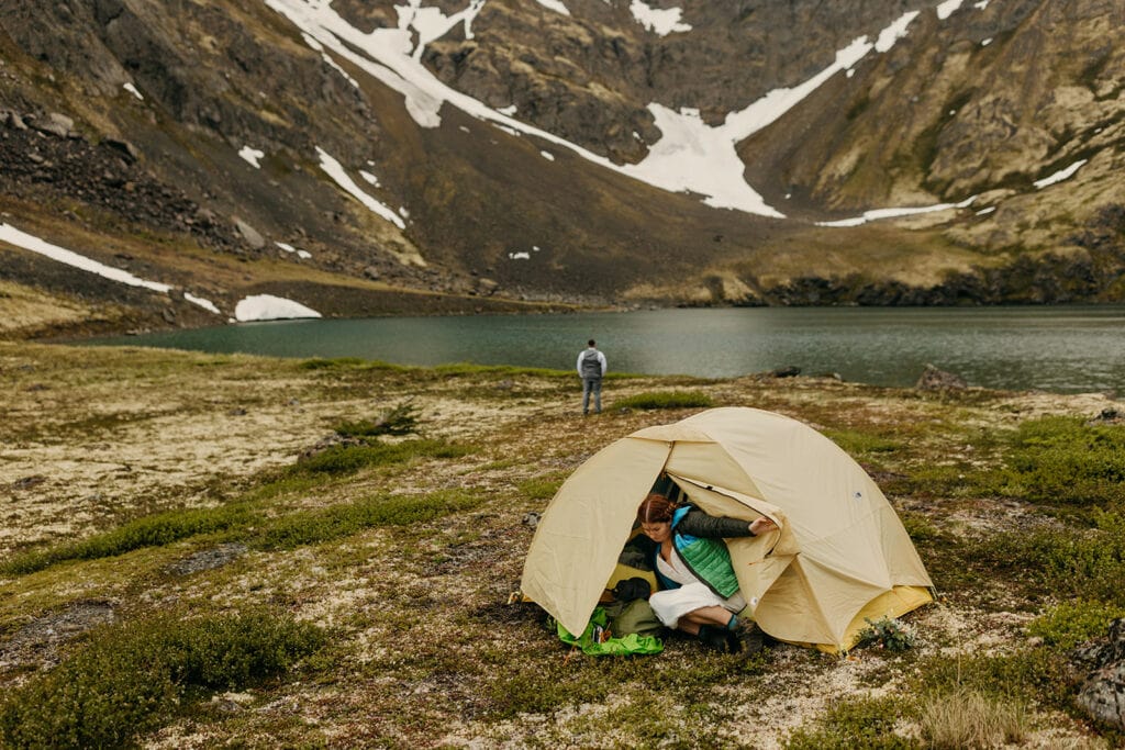 The bride gets out of her tent after changing into her wedding dress.