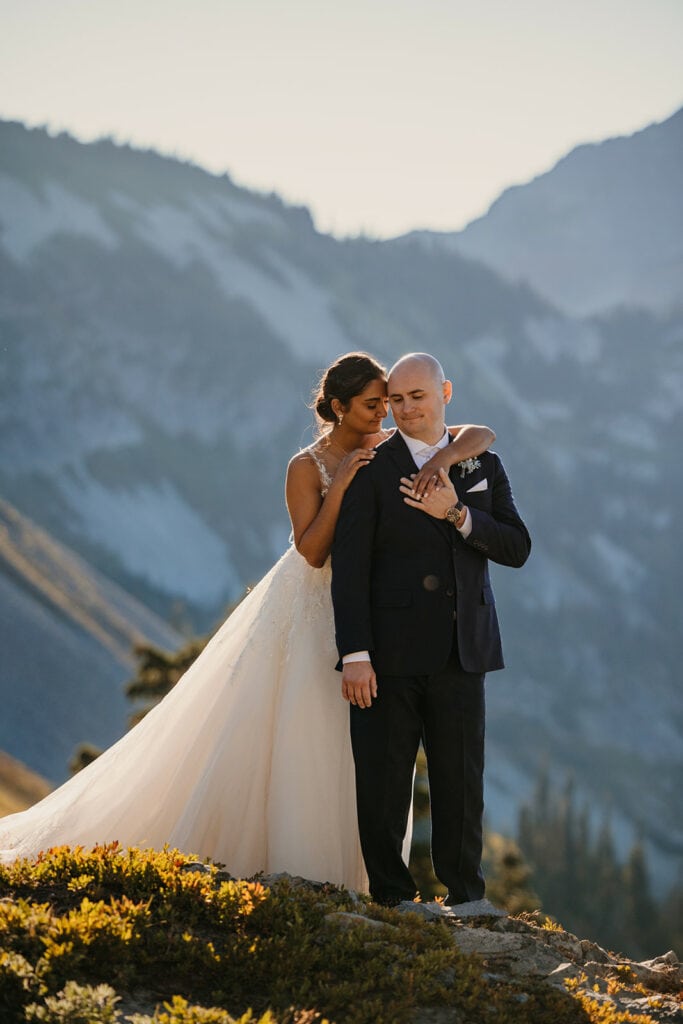 A soft moment between the couple holding each other close.