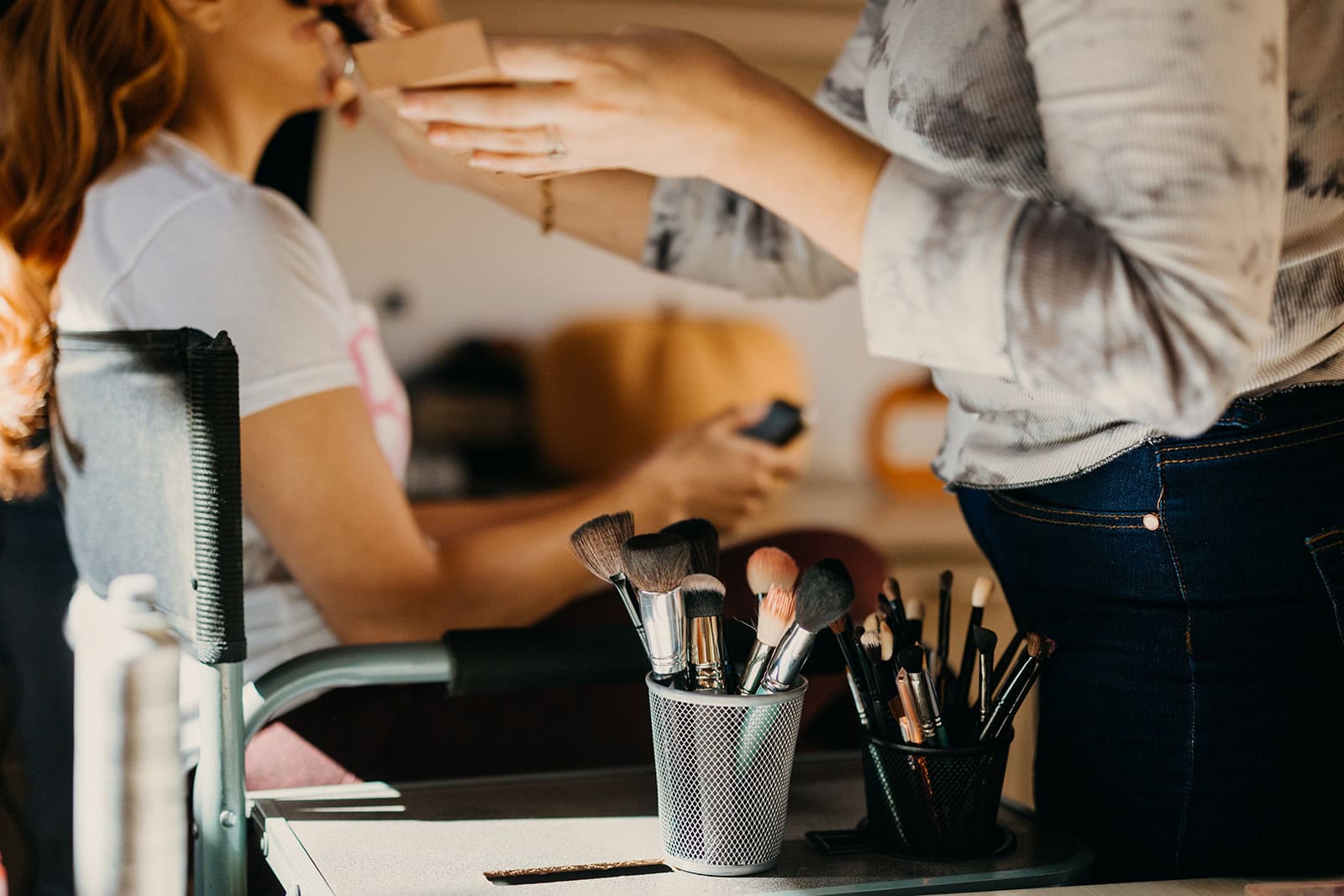 A detail photo of a makeup artist's brushes.