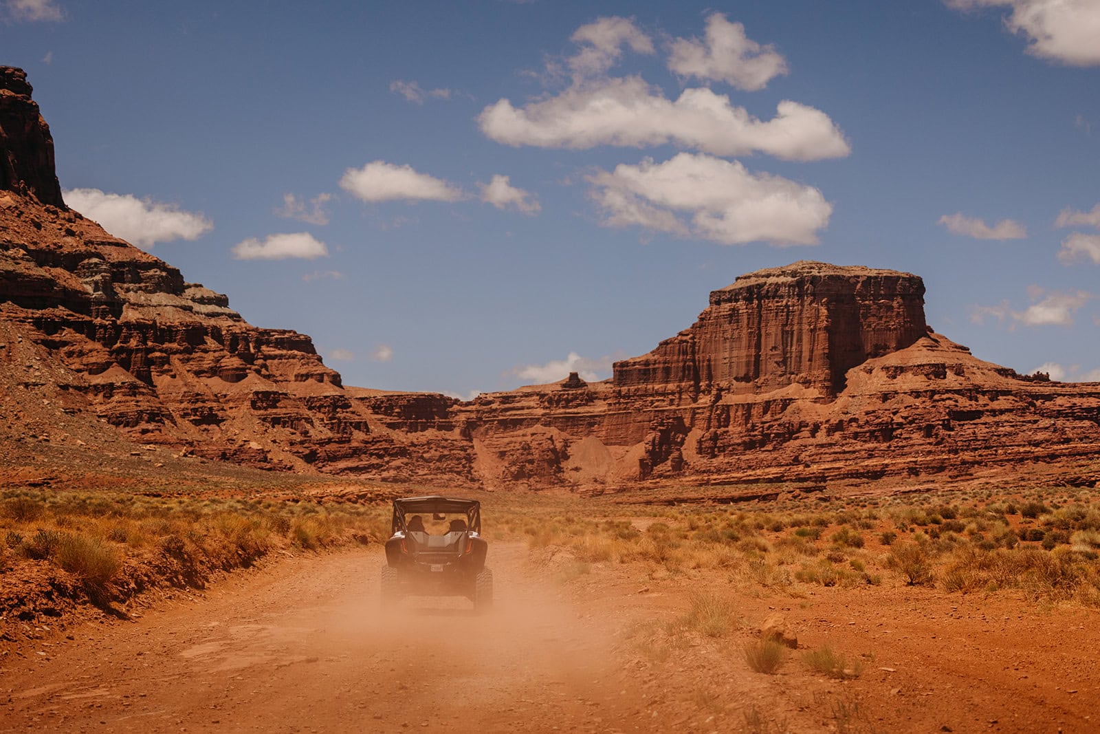 An off-road vehicle driving through the canyons around Moab