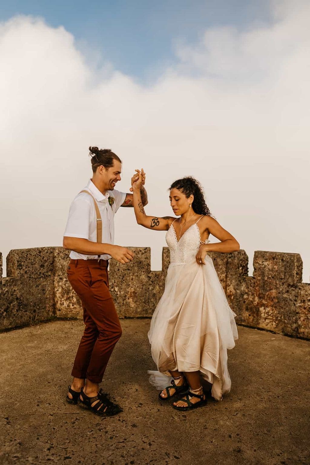 A bride and groom dance to salsa.