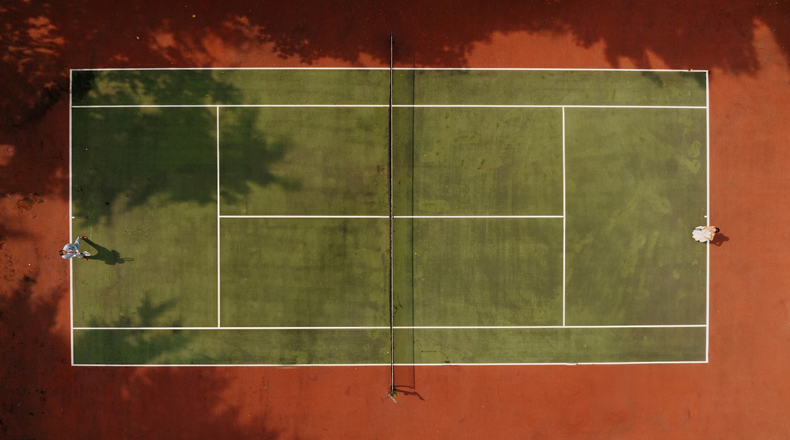 A couple plays tennis to start off their elopement day.