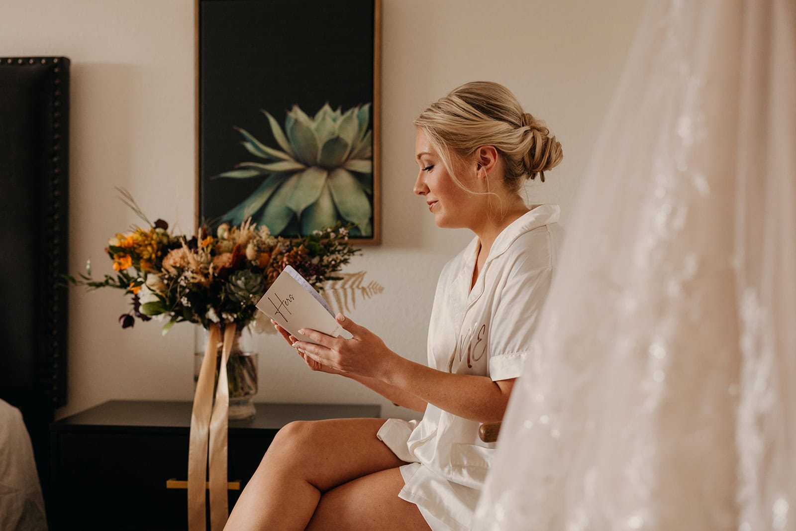 A bride reads her vows before putting her dress on after getting ready.