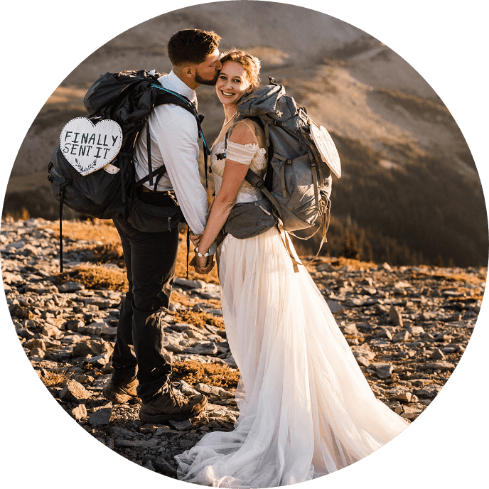 A person kissing their partner's cheek while they hold hands