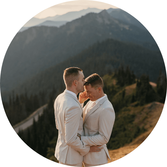 A person about to kiss their partner's cheek as their hands are on each other's waists