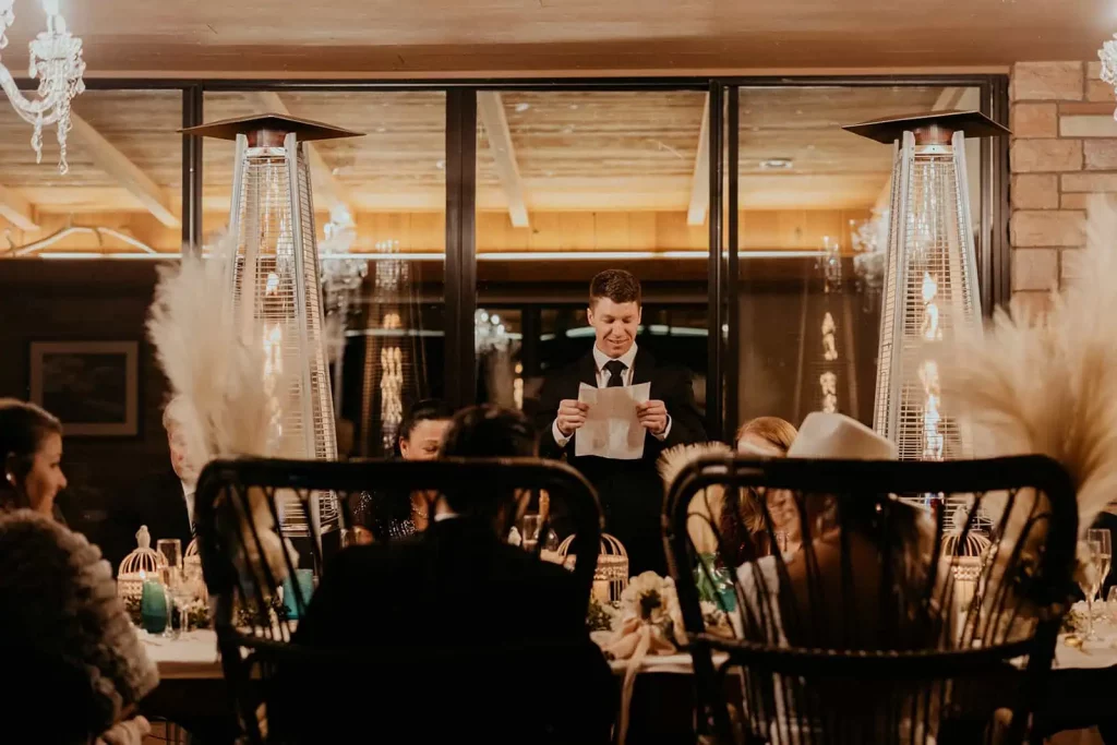 A guest of the wedding reads a letter to the bride and groom.