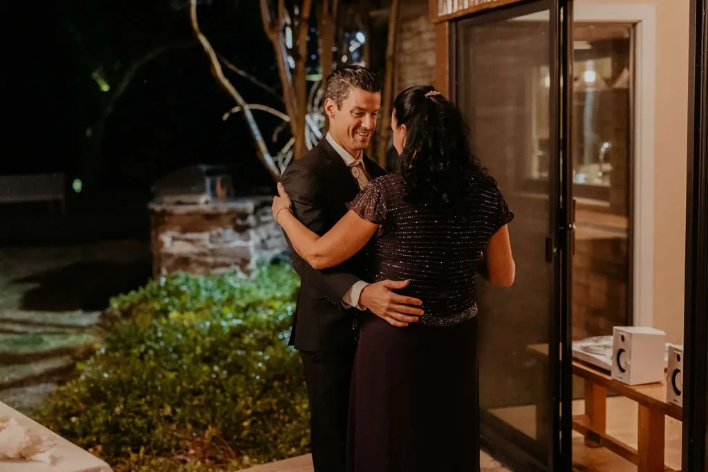 A mother and the groom sharing a dance together.